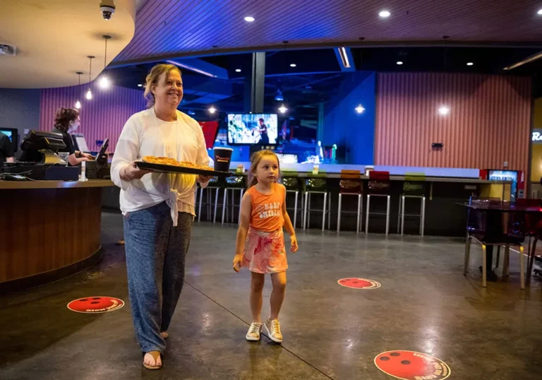 Woman and young child getting some pizza at PRemier LAnes