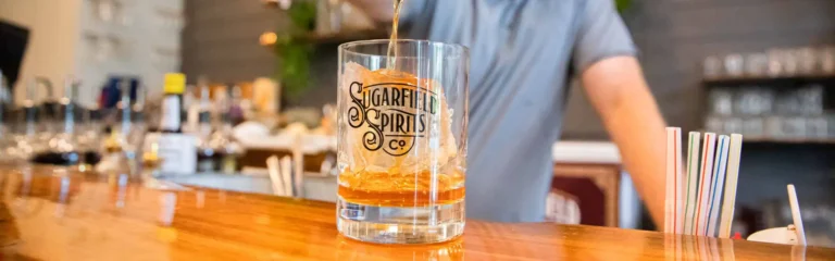bartender pouring a cocktail